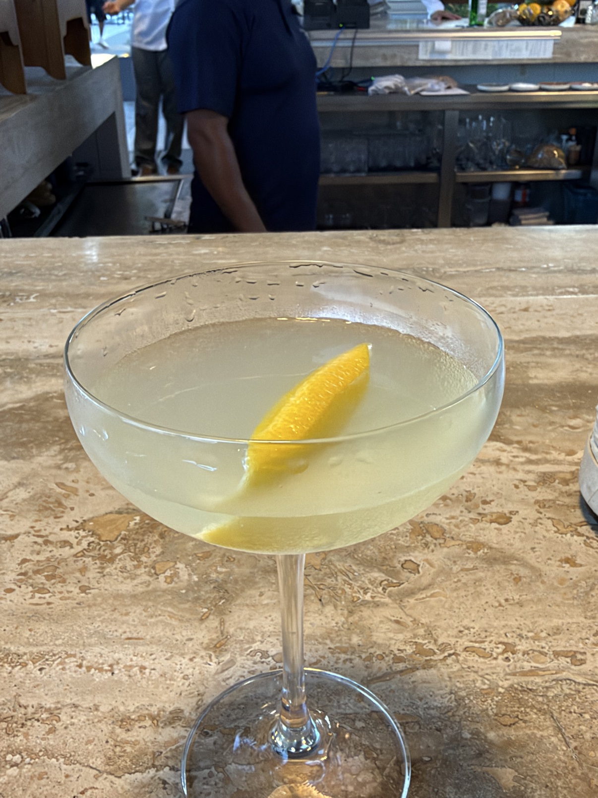 The Last Word at the bar at Solaz — pale green, served up, lemon twist.
