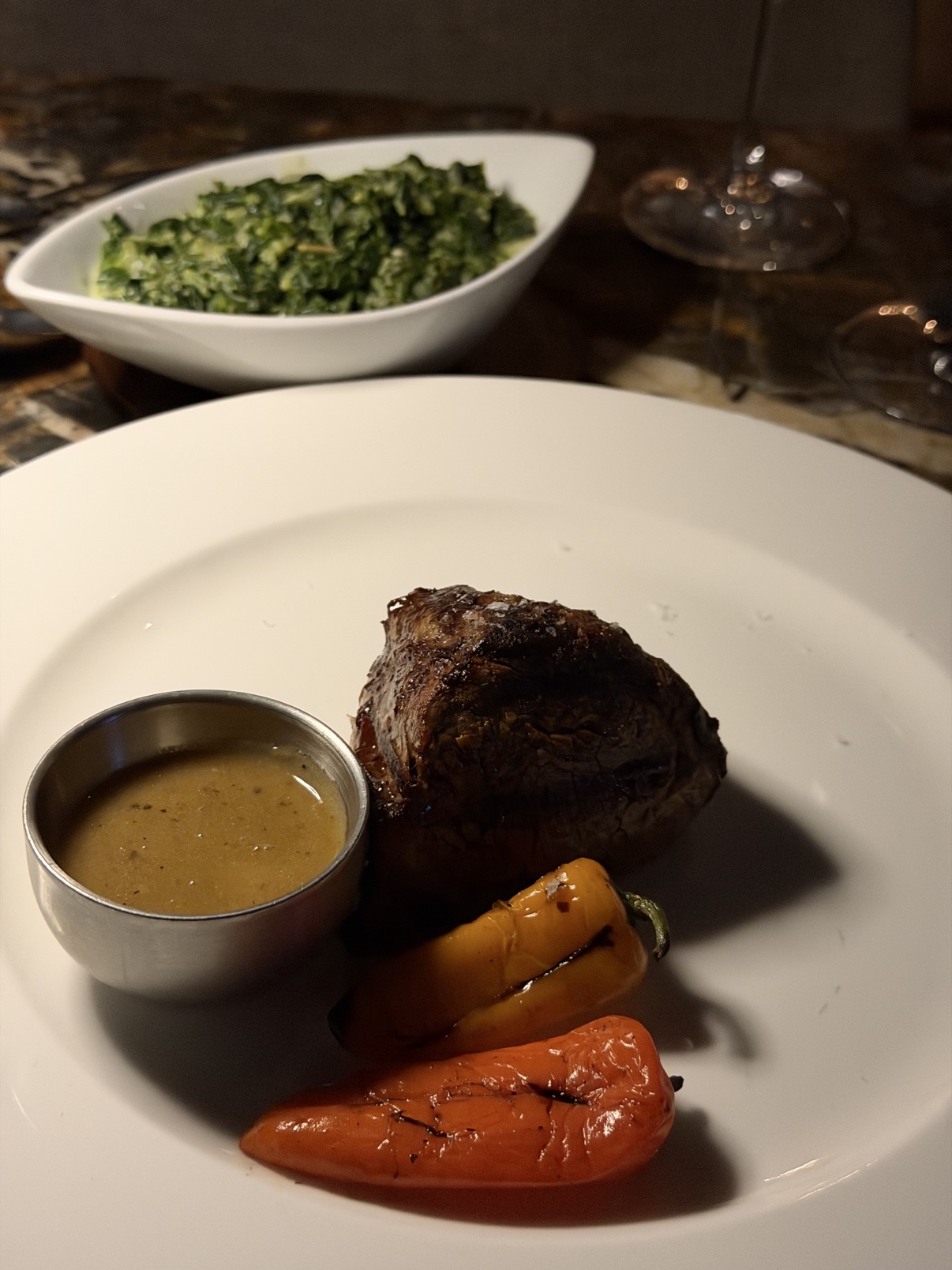 The 9 oz filet, medium rare — with the Creamed Spinach behind it.